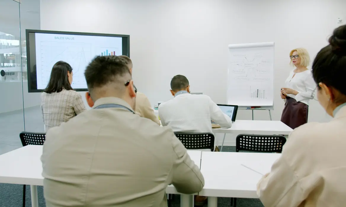Trainer guiding a team through practical exercises